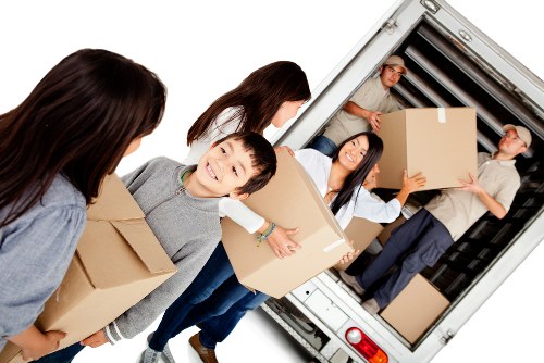 Packed household items and moving equipment prepared for a Creekmouth relocation